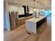 Sleek kitchen features stainless steel appliances, a large island, and modern pendant lighting at 2405 S Franklin, Denver, CO 80210