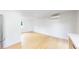 Versatile living space with hardwood floors, a mini-split system, and a partial view of the kitchen at 2405 S Franklin, Denver, CO 80210