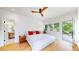Serene main bedroom with hardwood floors, a ceiling fan, an ensuite bathroom, and access to a balcony at 2405 S Franklin, Denver, CO 80210