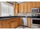 Well-equipped kitchen with ample wood cabinetry and granite counters at 10810 W 63Rd Ave # C, Arvada, CO 80004