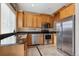 Modern kitchen with stainless steel appliances and wood cabinets at 10810 W 63Rd Ave # C, Arvada, CO 80004