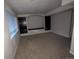 Finished basement with carpeted floors and built-in shelving at 17 Ellendale St, Castle Rock, CO 80104