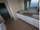 Double vanity bathroom with tile flooring and a large mirror at 17 Ellendale St, Castle Rock, CO 80104