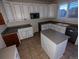 Spacious kitchen featuring an island and white cabinets at 17 Ellendale St, Castle Rock, CO 80104