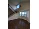 Two-story living room with hardwood floors and bay window at 17 Ellendale St, Castle Rock, CO 80104