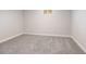 Carpeted basement with neutral gray walls and a small window for natural light at 15 Hazel Ct, Denver, CO 80219