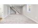 Spacious carpeted basement with staircase and a window providing natural light at 15 Hazel Ct, Denver, CO 80219