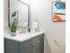 Bathroom vanity with a large mirror and accent artwork, highlighting the modern fixtures and design elements at 15 Hazel Ct, Denver, CO 80219