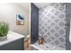 Stylish bathroom showcases unique tile work in the shower, with contrasting dark and patterned tiles for a modern look at 15 Hazel Ct, Denver, CO 80219