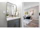 Stylish bathroom with a modern vanity, gold fixtures, and a glimpse into the cozy living room at 15 Hazel Ct, Denver, CO 80219