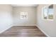 An empty bedroom with neutral walls, wood floors, and natural light from the windows, perfect for personalization at 15 Hazel Ct, Denver, CO 80219
