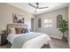 Cozy bedroom with ceiling fan, neutral walls, wood-look floors, complemented by modern decor and artwork at 15 Hazel Ct, Denver, CO 80219