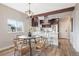 Dining Area featuring modern light fixture, wood-look flooring and a view of the kitchen at 15 Hazel Ct, Denver, CO 80219