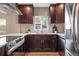 A close up shot of the kitchen, highlighting the stainless steel appliances and cherry wood cabinets at 15 Hazel Ct, Denver, CO 80219