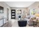 Bright and inviting living room area with modern black door and gray and black decor at 15 Hazel Ct, Denver, CO 80219