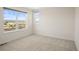 Bright bedroom featuring large windows and carpeted floors at 2829 S Fox Ct, Englewood, CO 80110