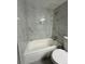 Bathroom featuring a toilet, and tiled shower and tub at 10211 Ura Ln # 7-108, Thornton, CO 80260