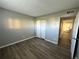This bedroom features wood-look floors, gray walls, and a double closet at 10211 Ura Ln # 7-108, Thornton, CO 80260