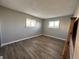 This bedroom has gray walls, wood-look floors, and natural light from the window at 10211 Ura Ln # 7-108, Thornton, CO 80260