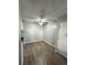 Dining room area with hardwood floors, a ceiling fan, and a door leading to another room at 10211 Ura Ln # 7-108, Thornton, CO 80260