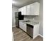 Kitchen area featuring stainless steel appliances, white cabinets, and granite countertops at 10211 Ura Ln # 7-108, Thornton, CO 80260