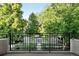 Balcony with views of the street, mature trees and landscaped yard at 325 S High St, Denver, CO 80209