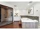 Spacious bathroom featuring a soaking tub and a separate glass-enclosed shower with tile surround at 325 S High St, Denver, CO 80209