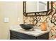 Stylish powder room with granite countertop, vessel sink and decorative mirror at 325 S High St, Denver, CO 80209
