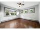 Comfortable bedroom with three windows offering ample natural light and hardwood floors at 325 S High St, Denver, CO 80209