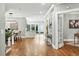 Spacious dining room featuring hardwood floors, modern light fixture, and bar with glass doors to backyard at 325 S High St, Denver, CO 80209