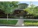 Charming home with a brick facade, balcony, manicured lawn and garden at 325 S High St, Denver, CO 80209