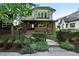 Charming two-story home features a front porch and manicured landscaping with a fence at 325 S High St, Denver, CO 80209