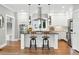 Bright kitchen with white cabinetry, a central island with seating, and stainless steel appliances at 325 S High St, Denver, CO 80209