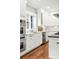 Bright, modern kitchen features white cabinets, stainless steel appliances, and a window above the sink at 325 S High St, Denver, CO 80209