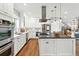 Bright kitchen features a large island, stainless steel appliances and beautiful hardwood floors at 325 S High St, Denver, CO 80209