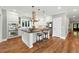 Spacious kitchen features stainless steel appliances, eat-in island, white cabinets, and modern lighting fixtures at 325 S High St, Denver, CO 80209