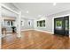 Bright living room features gleaming hardwood floors, neutral walls, and a door leading to another room at 325 S High St, Denver, CO 80209
