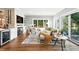 Cozy living room with a stone fireplace, large windows, hardwood floors and modern furnishings at 325 S High St, Denver, CO 80209