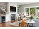 Cozy living room with stone fireplace, mounted TV, window seat, and comfortable seating area at 325 S High St, Denver, CO 80209
