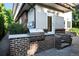 Built-in outdoor BBQ, stone countertop, and brick accents provide a luxurious outdoor cooking experience at 325 S High St, Denver, CO 80209