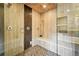 Modern walk-in shower with pebble flooring, bench, and dual shower heads, offering a spa-like experience at 325 S High St, Denver, CO 80209