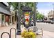 Charming street view with a park bench and flower stand, near retail shops at 325 S High St, Denver, CO 80209