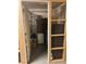 Basement storage area with wooden frame, wire mesh, door, and miscellaneous stored household items at 2210 E Mississippi Ave # 3, Denver, CO 80210