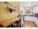 Bright kitchen features white cabinets, stainless steel appliances, and a wooden breakfast bar with seating at 2210 E Mississippi Ave # 3, Denver, CO 80210