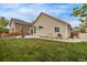 Spacious backyard featuring a concrete patio, lush green grass, and privacy fencing, perfect for outdoor activities at 14713 Josephine St, Thornton, CO 80602