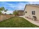 Expansive backyard with green grass, a concrete patio, and wooden fencing, ideal for outdoor living and entertaining at 14713 Josephine St, Thornton, CO 80602