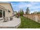 Well-kept backyard with lush green grass, a concrete patio, and a wooden fence offering a private outdoor space at 14713 Josephine St, Thornton, CO 80602