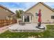 Backyard patio with seating area, patio umbrella, and adjacent grassy area, great for relaxing and enjoying the outdoors at 14713 Josephine St, Thornton, CO 80602