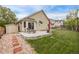 Backyard featuring a concrete patio with outdoor seating and lush grass, perfect for enjoying the outdoors and relaxing at 14713 Josephine St, Thornton, CO 80602
