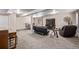 Large basement with an entertainment area with plush carpeting and a small seating area at 14713 Josephine St, Thornton, CO 80602